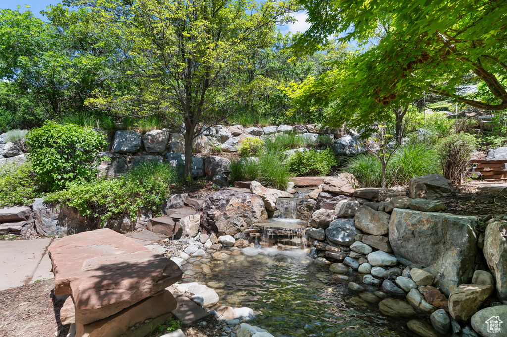View of yard with a garden pond