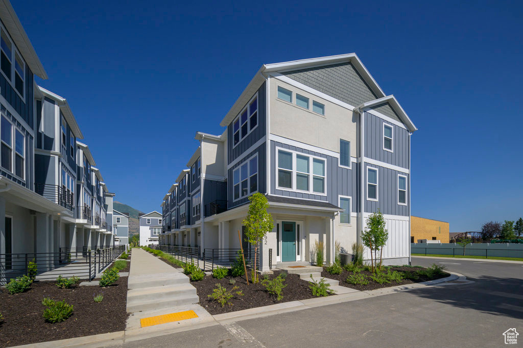 View of asphalt road featuring a residential view