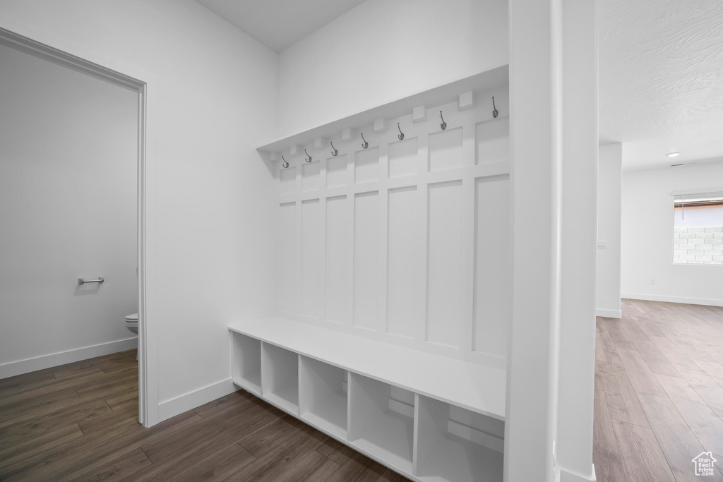 Mudroom with dark wood-style floors and baseboards