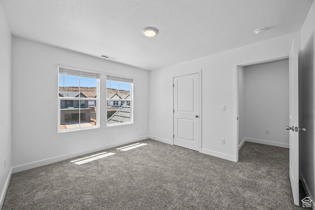 Unfurnished bedroom featuring carpet flooring and baseboards