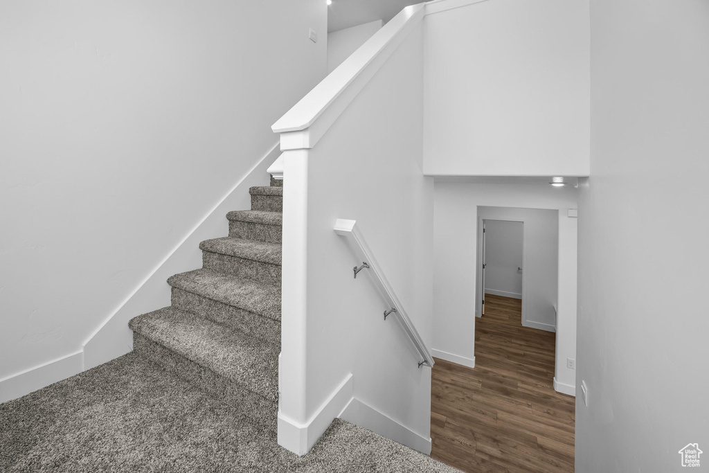Stairway with baseboards and wood finished floors