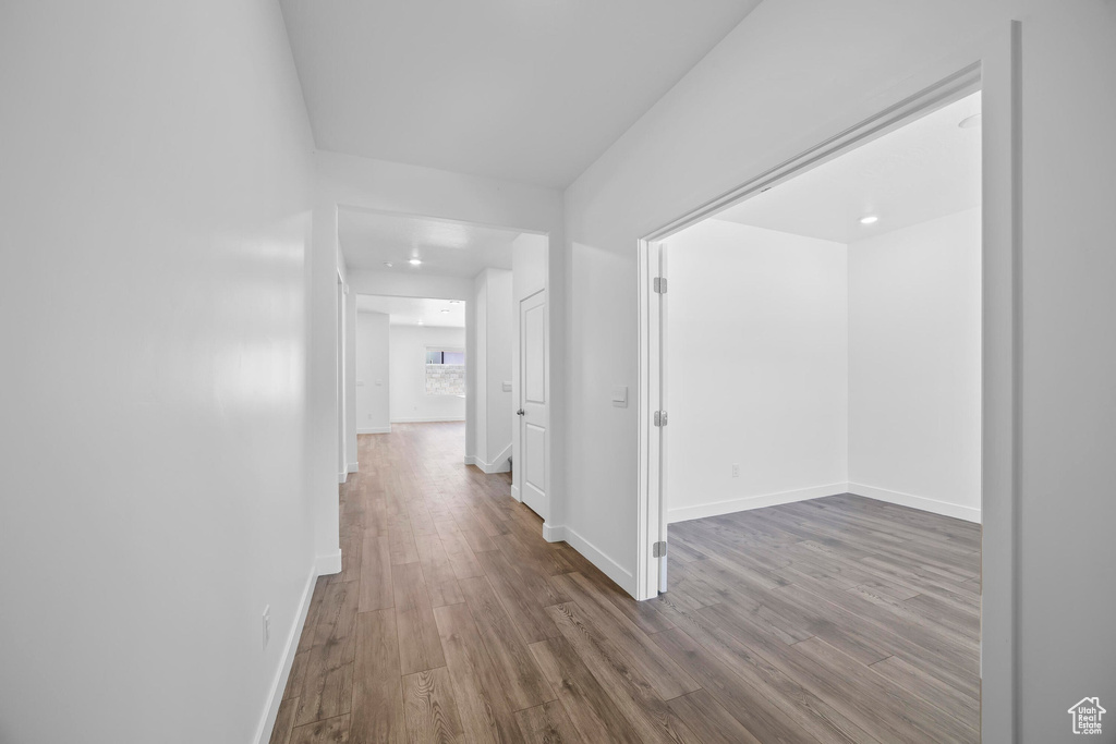 Hall with wood finished floors and baseboards