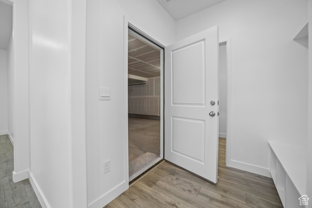 Interior space with baseboards and wood finished floors