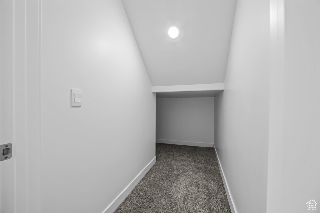 Hall with dark carpet, baseboards, and recessed lighting