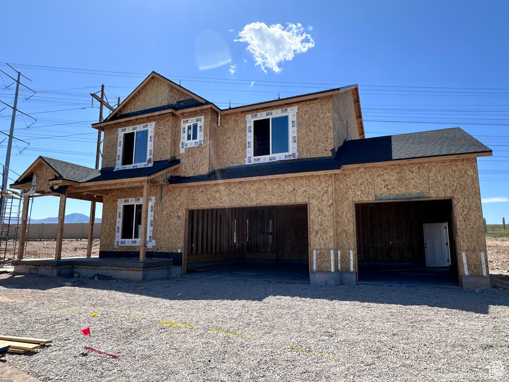 Property under construction featuring gravel driveway