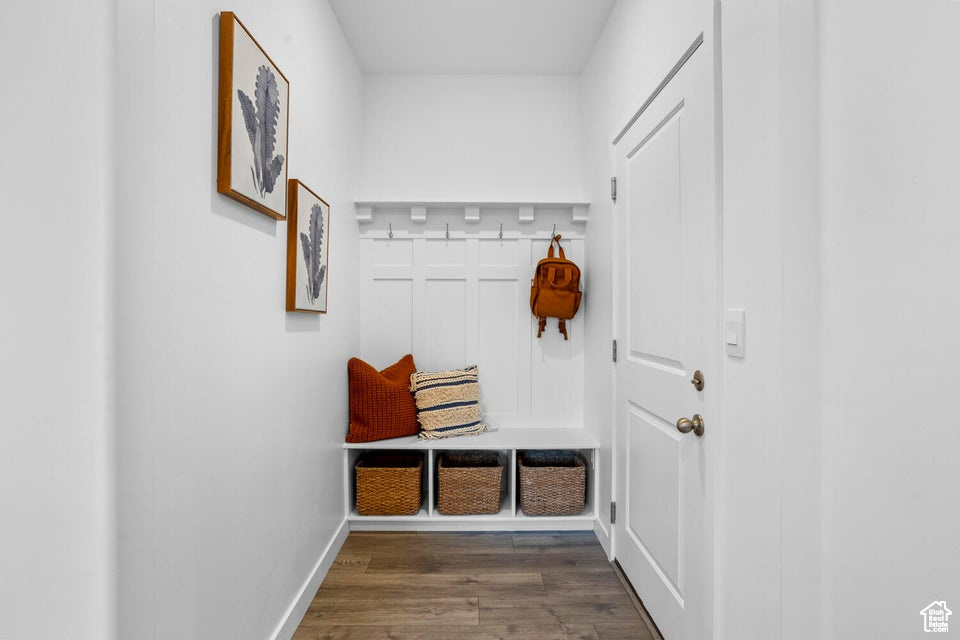 Mudroom with dark wood-style flooring and baseboards