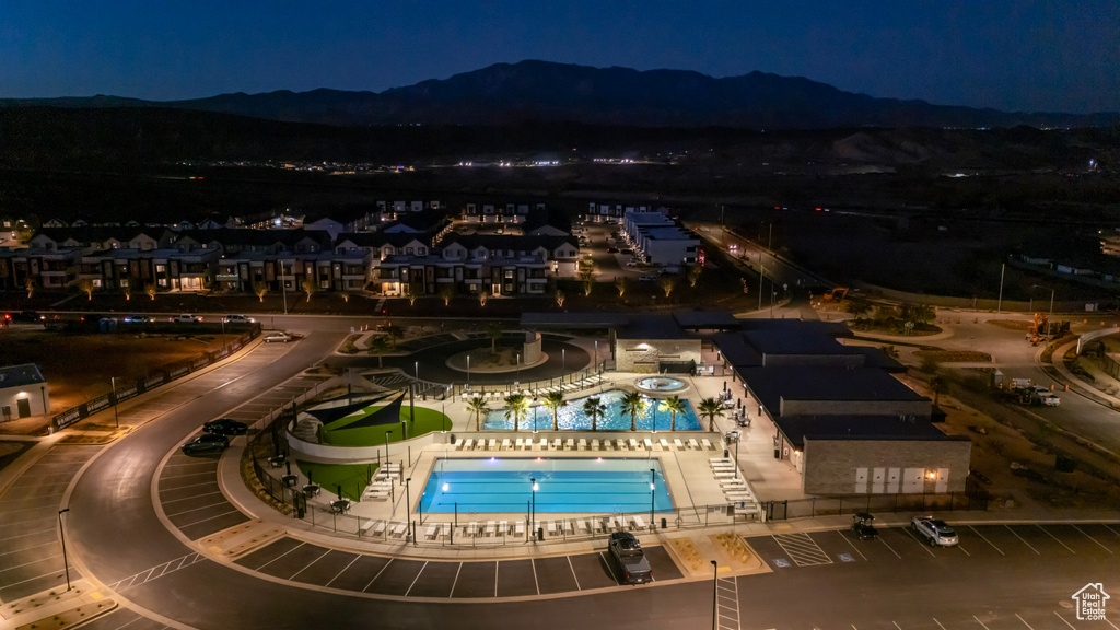 Aerial view at night of view of pool area and a mountain view