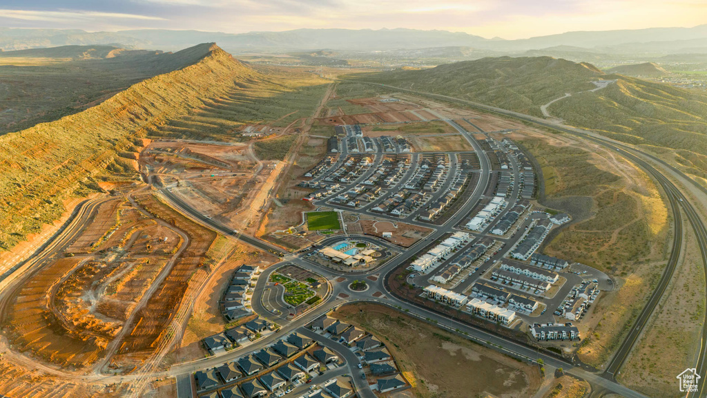 Aerial view of property and surrounding area featuring mountains