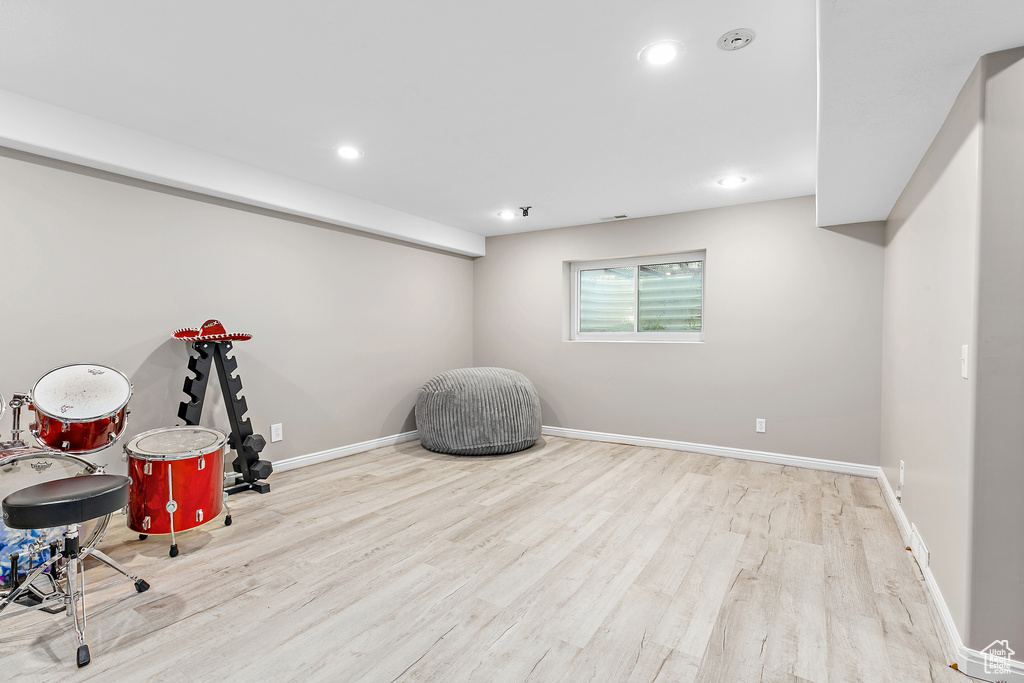 Workout room with wood finished floors, baseboards, and recessed lighting
