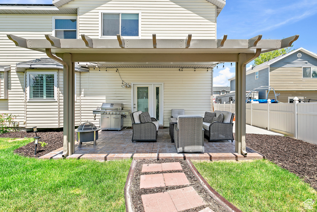 Rear view of house with an outdoor living space, a patio, and a pergola