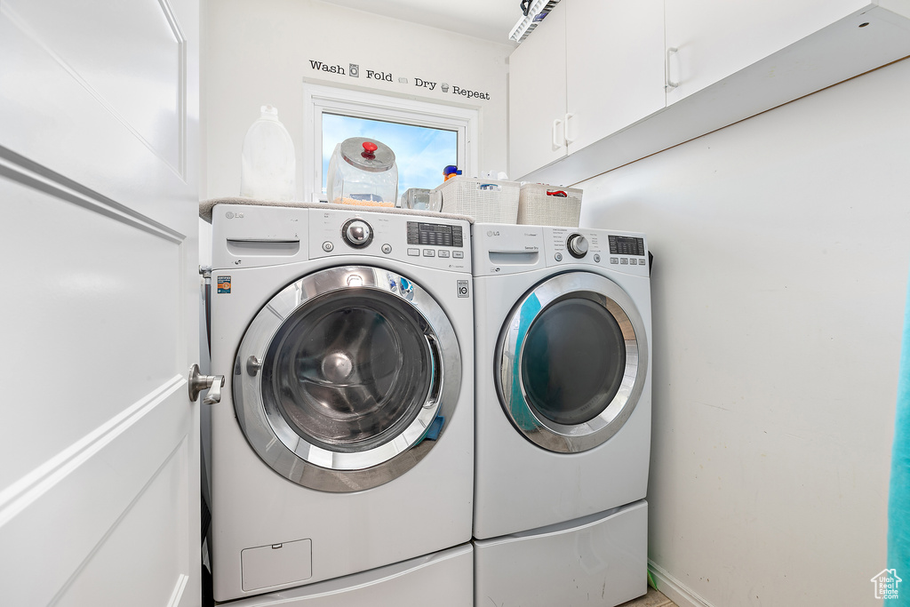 Laundry room with cabinet space and washer and dryer
