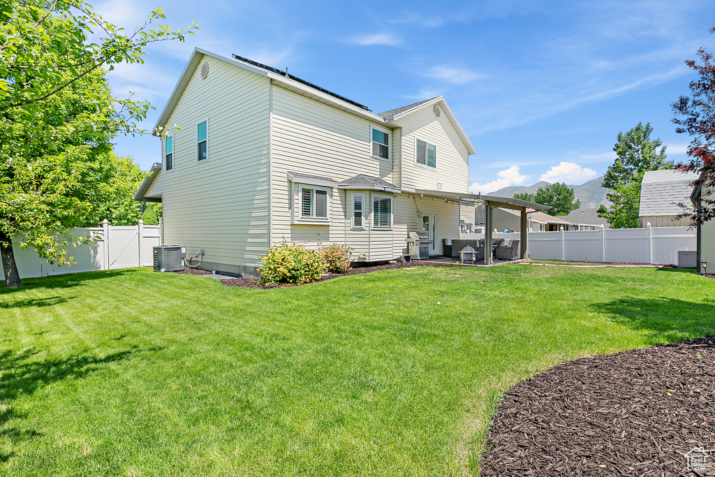 Rear view of property with central AC, a patio area, and a mountain view