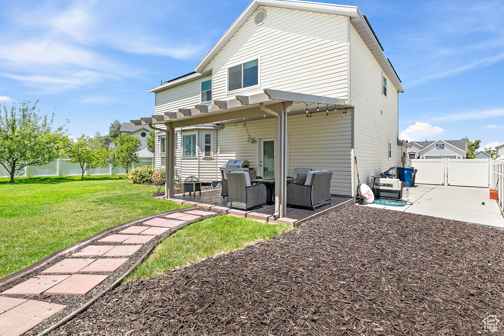 Rear view of house with a patio and an outdoor hangout area