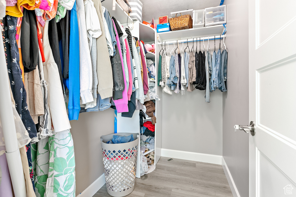 Walk in closet featuring wood finished floors