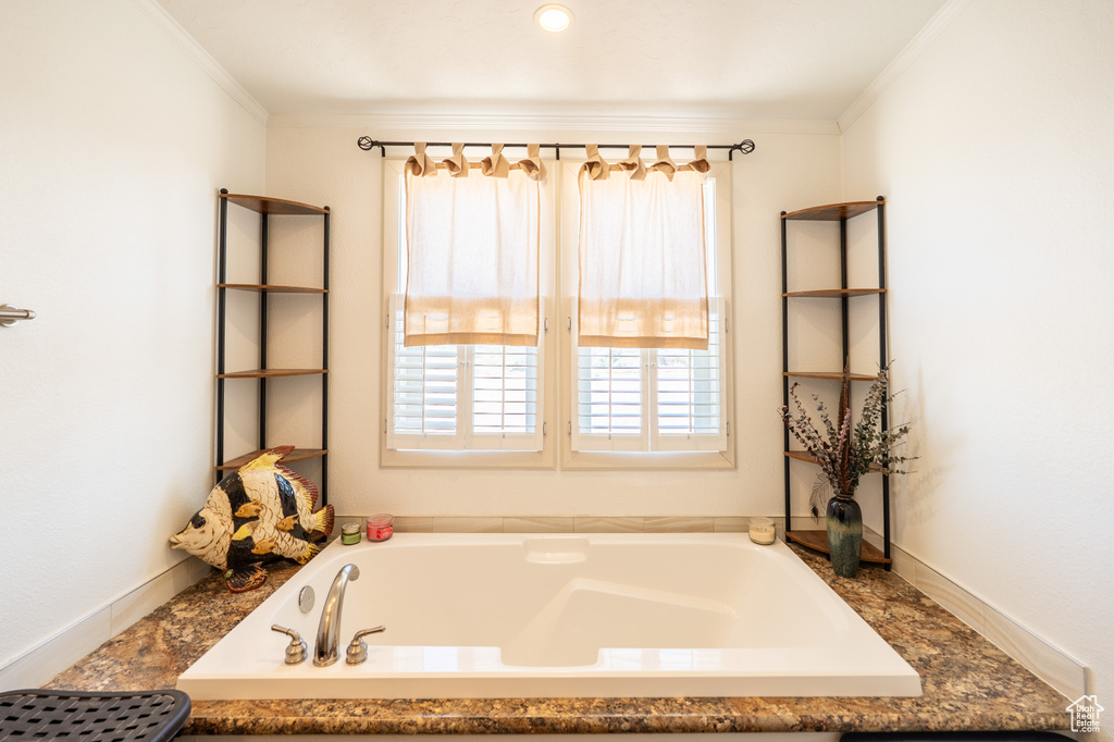 Full bathroom featuring crown molding and a bath