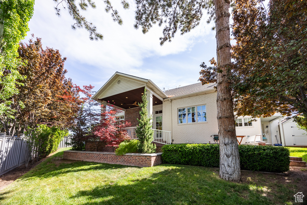 View of front of house with brick siding and ceiling fan