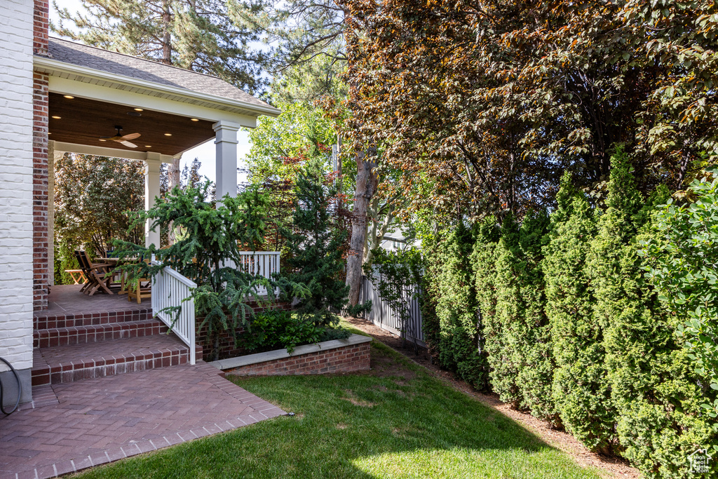 View of yard featuring a ceiling fan
