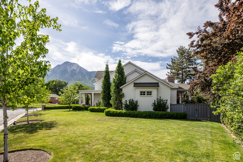 Exterior space with a mountain view and a gate