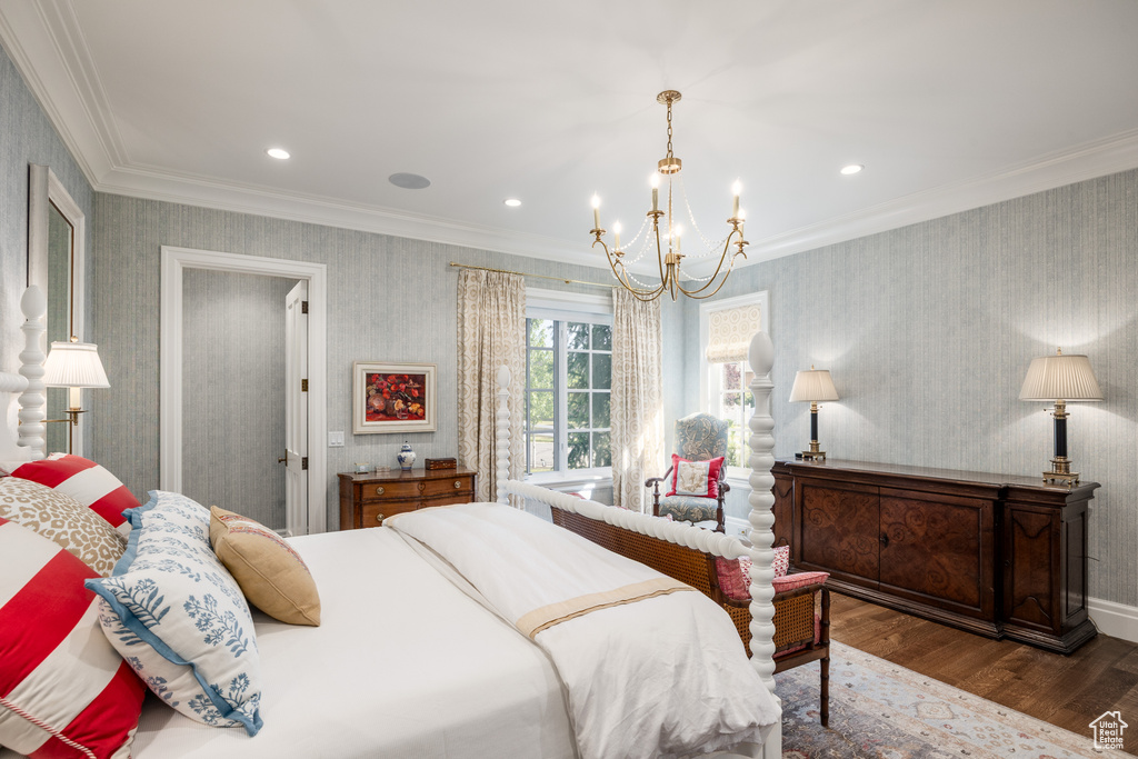 Bedroom with wood finished floors, a chandelier, wallpapered walls, crown molding, and recessed lighting