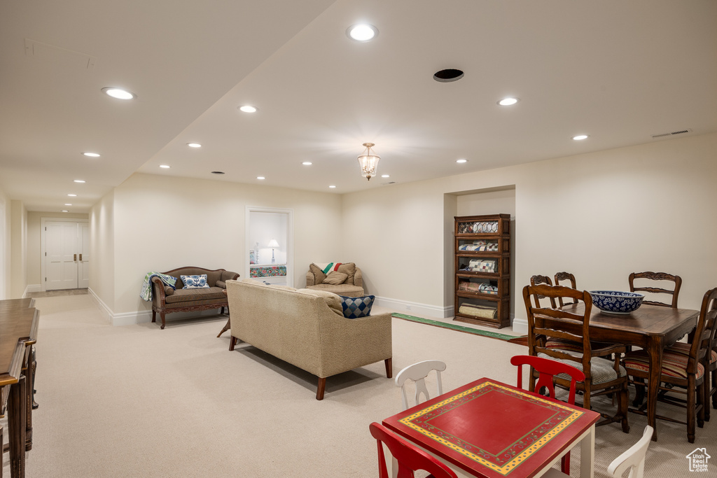 Living room featuring light colored carpet, recessed lighting, and baseboards