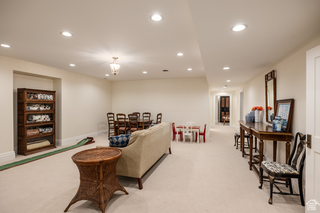 Living room featuring recessed lighting, light carpet, and baseboards