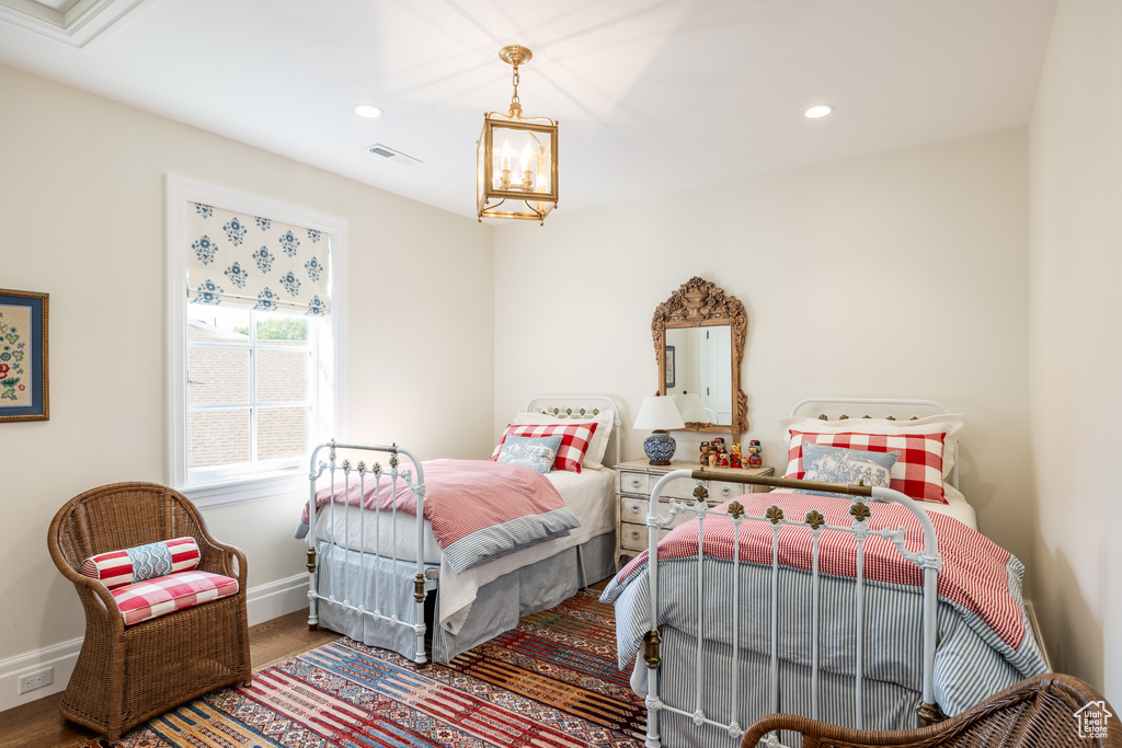 Bedroom featuring wood finished floors, baseboards, and recessed lighting