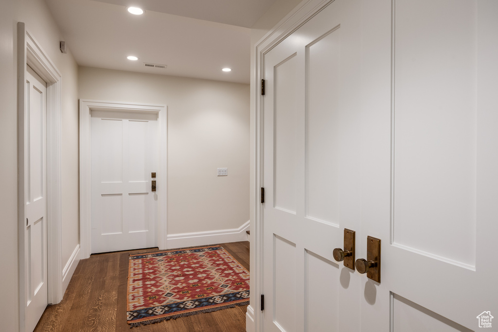 Hall featuring wood finished floors, recessed lighting, and baseboards
