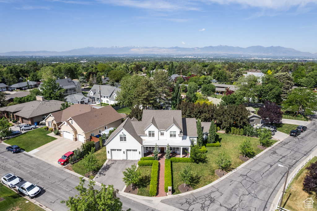 Aerial perspective of suburban area featuring a mountain backdrop