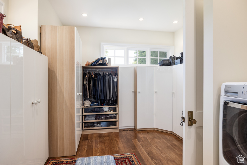 Laundry area with washer / dryer, wood finished floors, and recessed lighting
