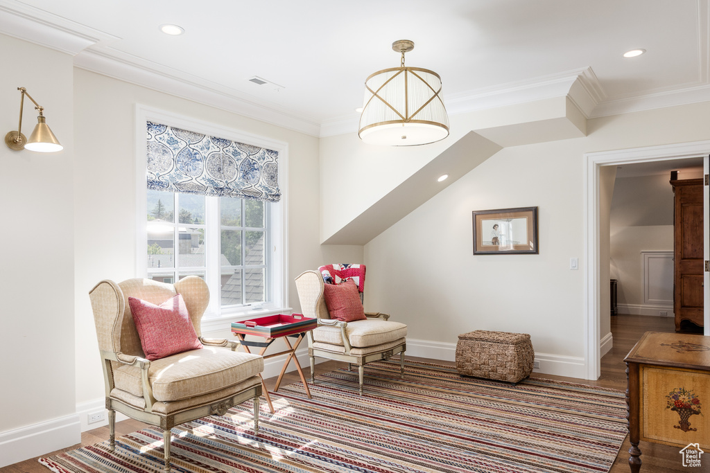 Sitting room featuring baseboards, crown molding, recessed lighting, and wood finished floors