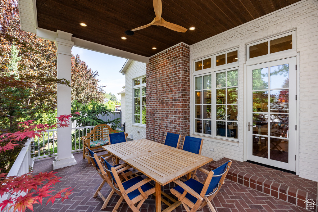 View of patio with a ceiling fan and outdoor dining area