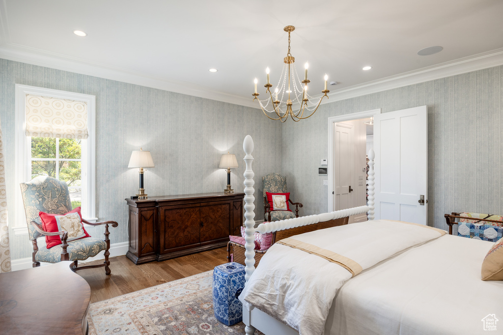 Bedroom with a chandelier, wood finished floors, wallpapered walls, and recessed lighting