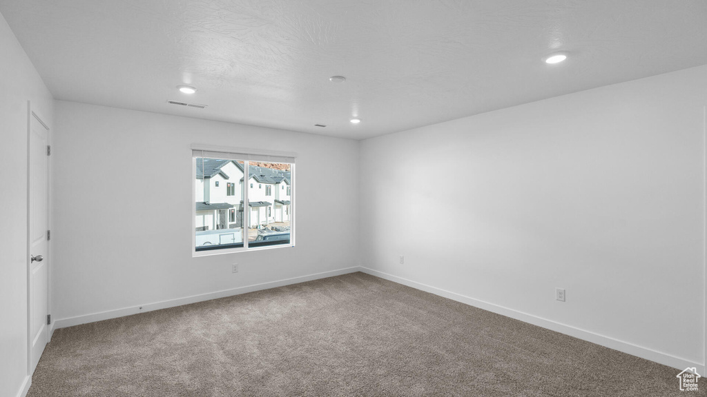 Unfurnished room with carpet floors, recessed lighting, and baseboards