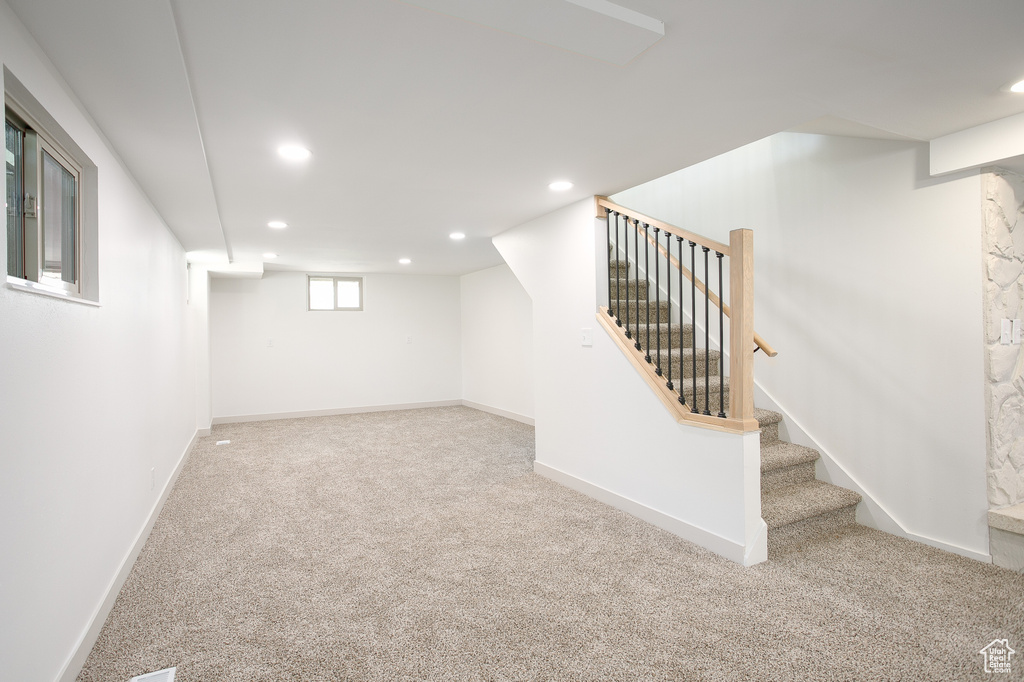 Basement with recessed lighting, carpet, stairs, and baseboards