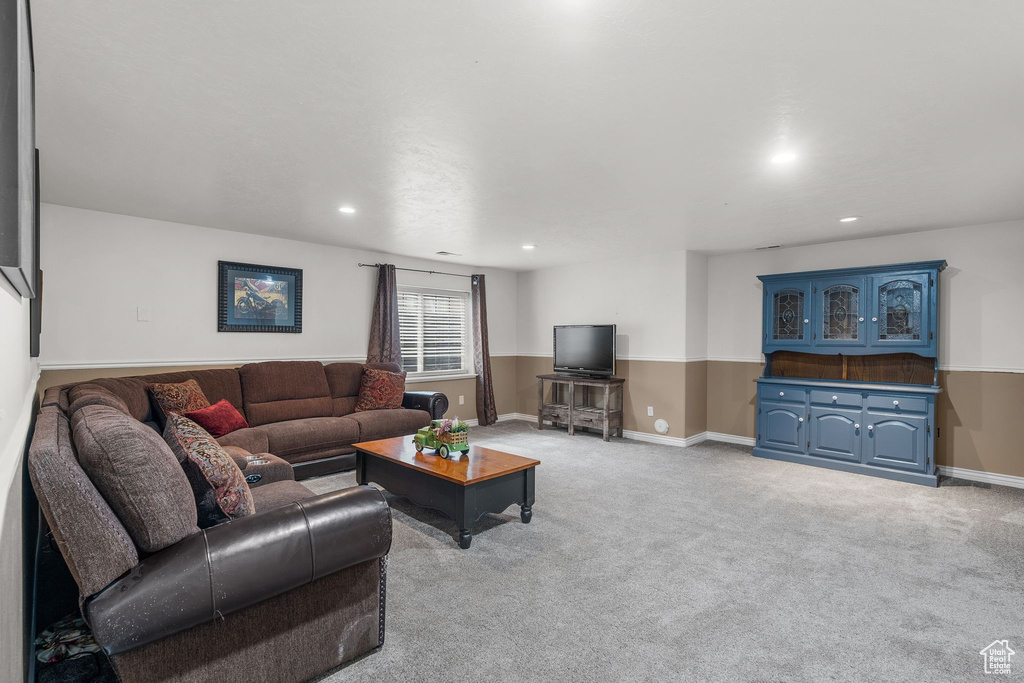 Living area with recessed lighting, baseboards, and light carpet