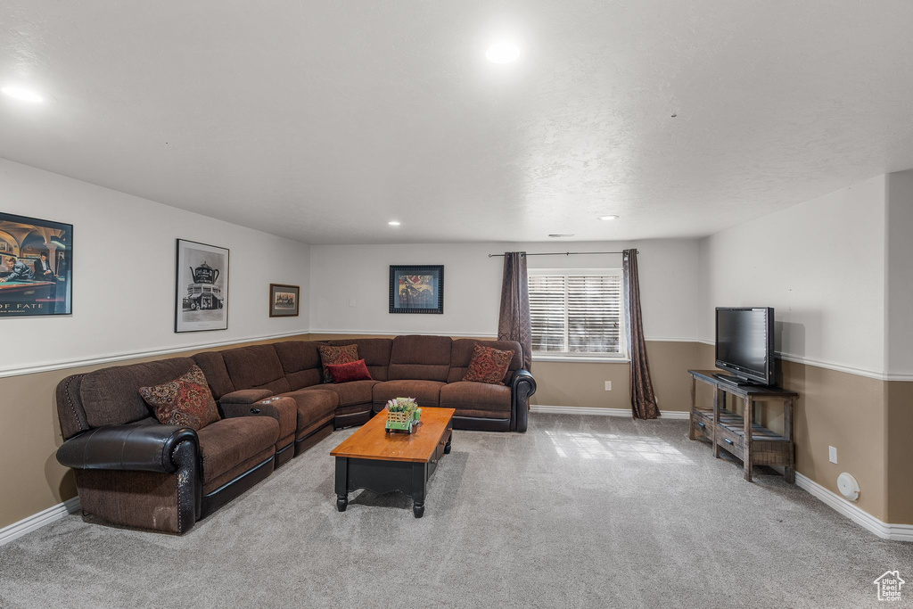 Carpeted living room featuring baseboards and recessed lighting