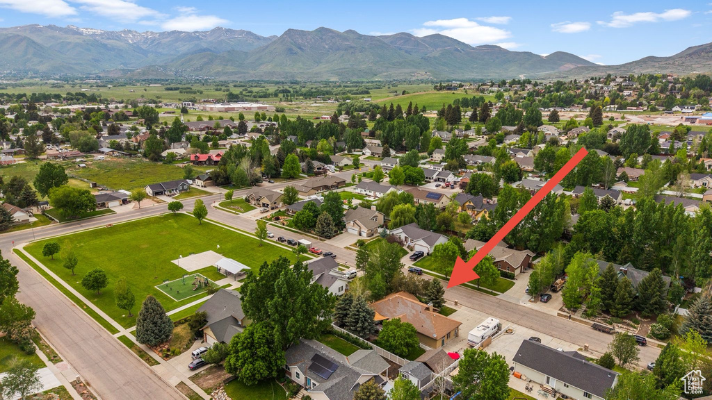Aerial perspective of suburban area featuring a mountain backdrop