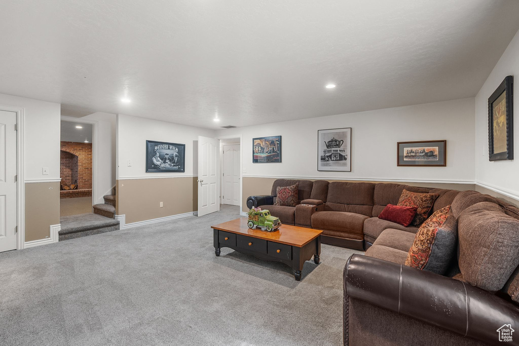 Living room featuring stairs, carpet, recessed lighting, and baseboards