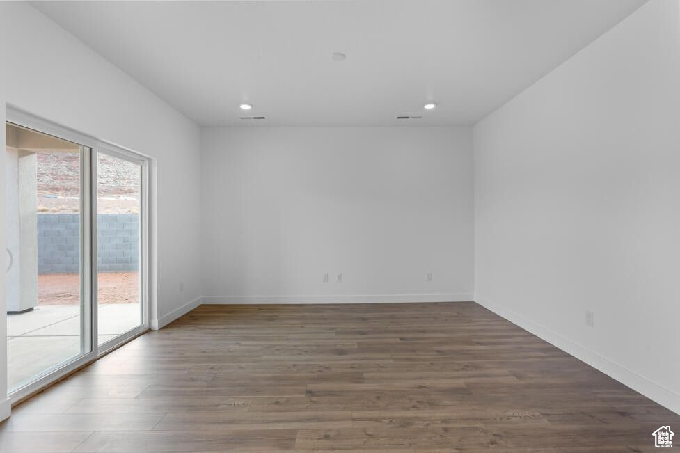 Unfurnished room featuring recessed lighting, wood finished floors, and baseboards
