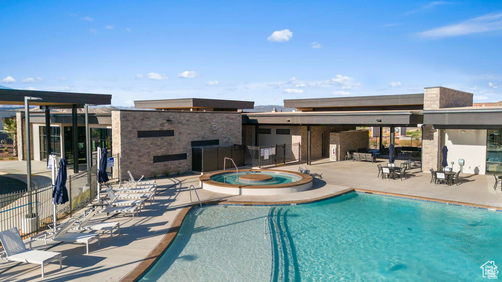 Community pool with a hot tub and a patio