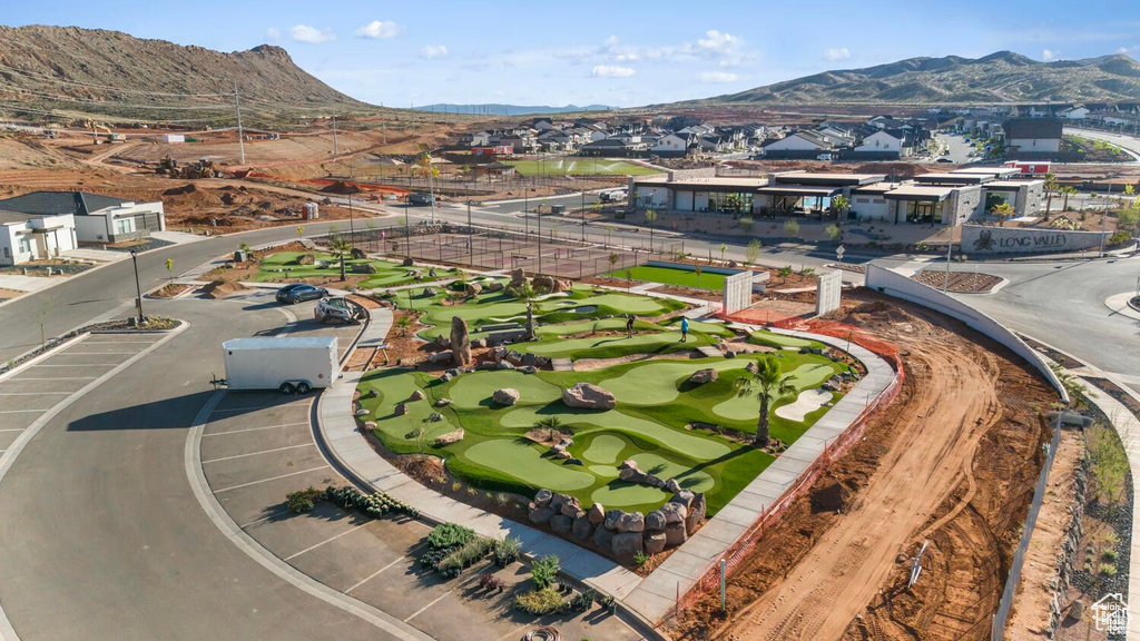 Aerial view of residential area featuring mountains and a golf course
