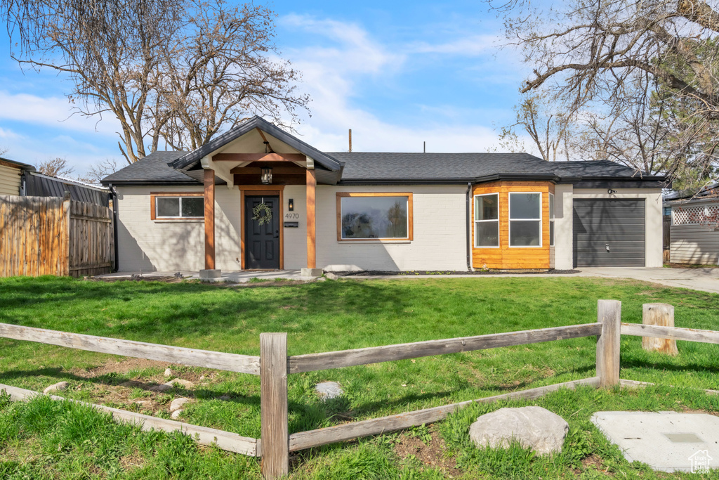 View of front of home featuring an attached garage, concrete driveway, and roof with shingles