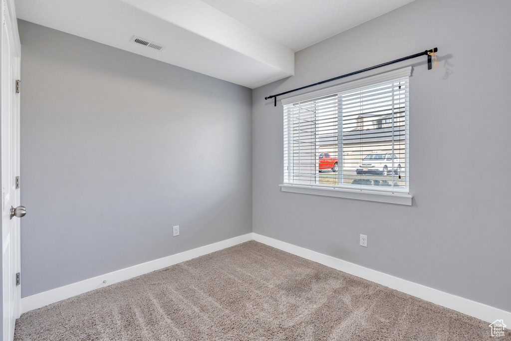 Carpeted spare room with baseboards