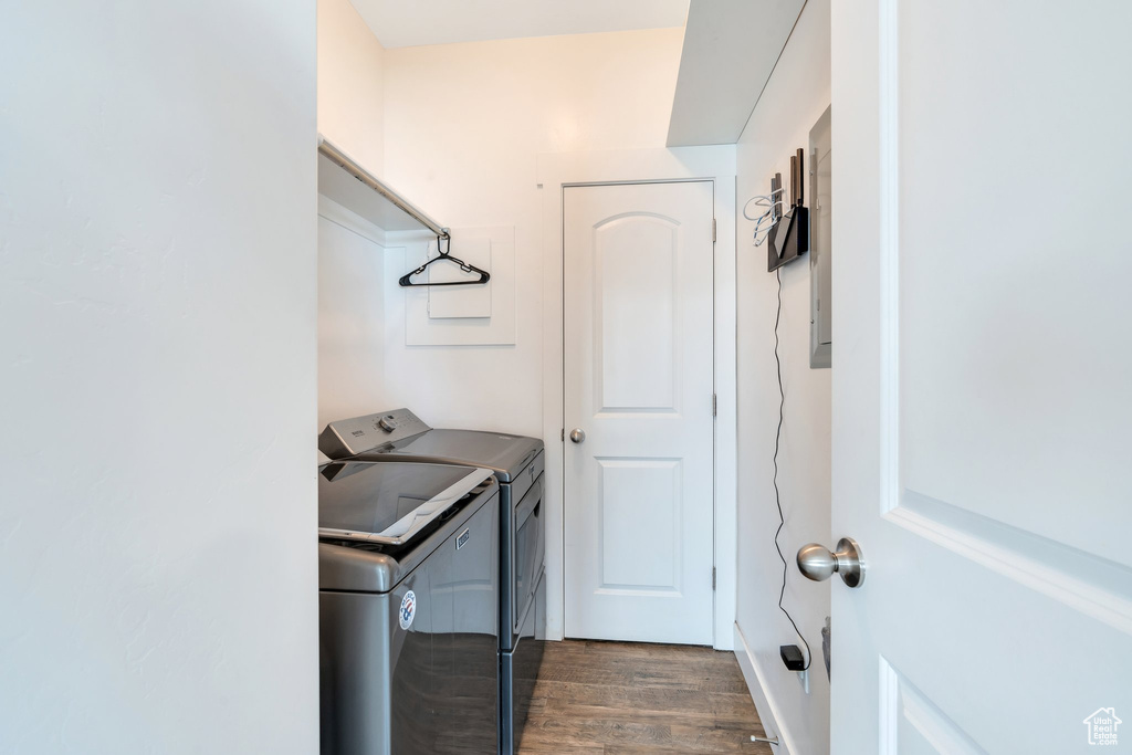 Laundry room featuring independent washer and dryer and dark wood finished floors