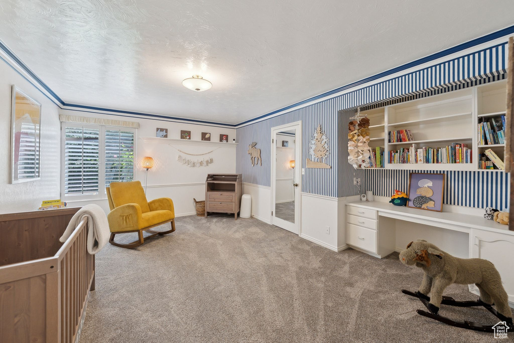 Living area featuring carpet and crown molding