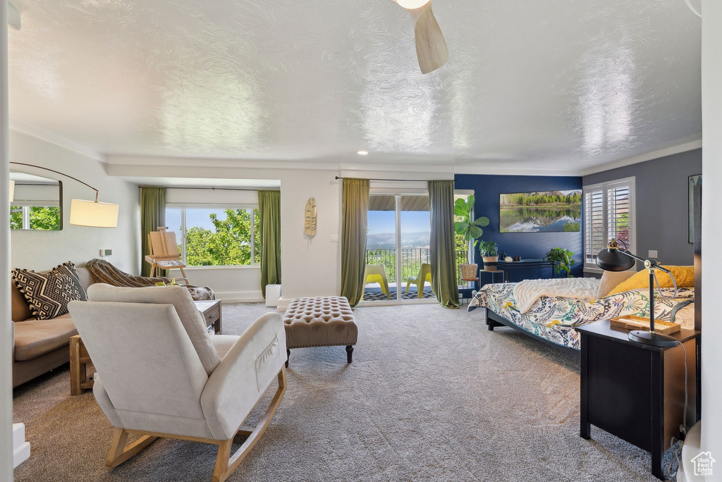 Carpeted bedroom featuring crown molding and a textured ceiling