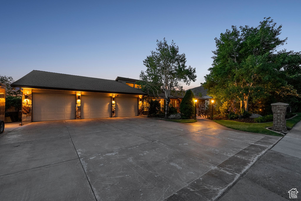 View of front of property with driveway and a garage