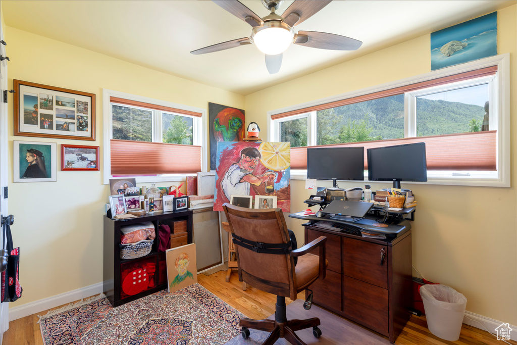Office space with ceiling fan, wood finished floors, and baseboards