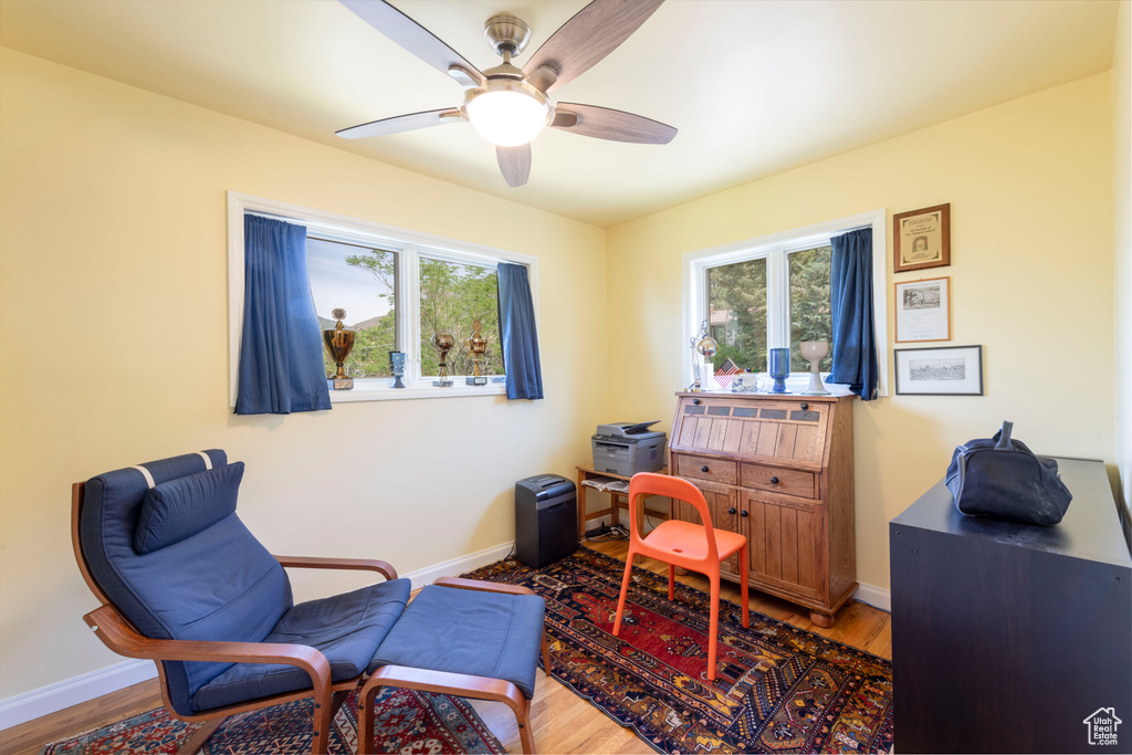 Office with healthy amount of natural light, wood finished floors, ceiling fan, and baseboards