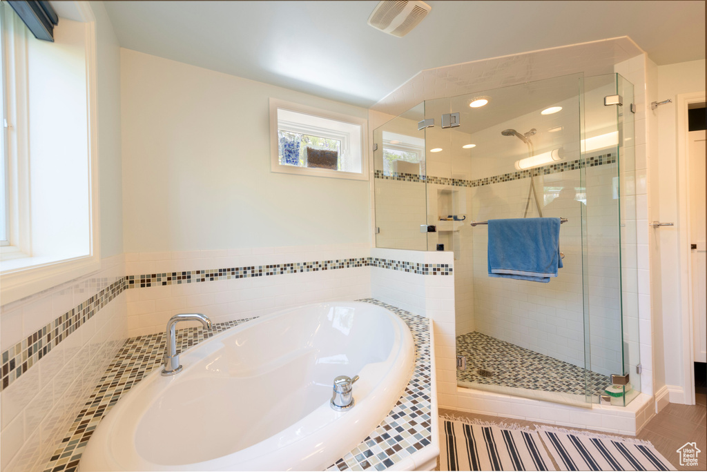 Bathroom with a bath, a shower stall, and recessed lighting